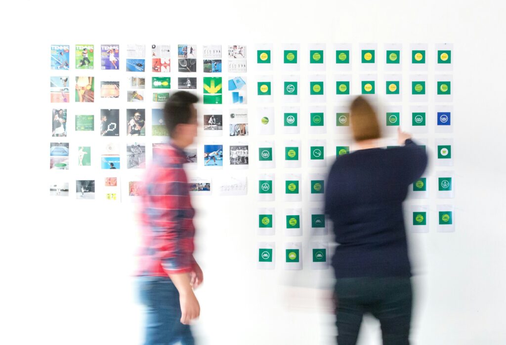 two people in motion blur looking at a wall with posted signs
