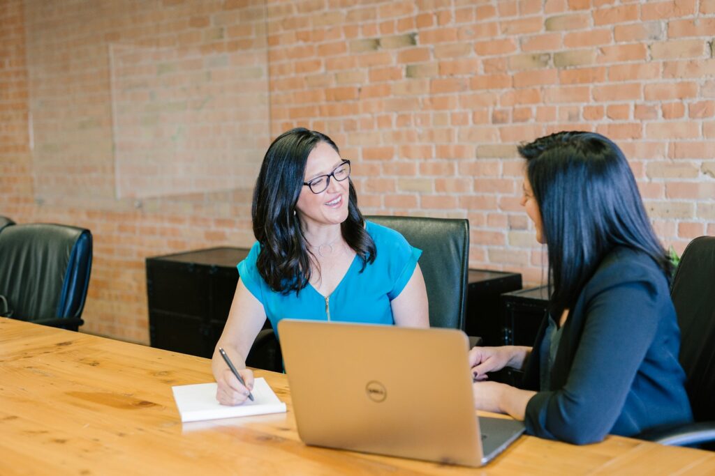 A consultant welcoming a new client at a shared table